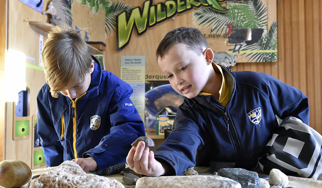 Students looking at rock samples in the Kosciuszko Education Centre in Kosciuszko National Park. Photo: Adam Hollingworth &copy; DPE