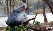 An Aboriginal guide from Minga Aboriginal Cultural Services conducting a smoking ceremony. Photo &copy; Toby Whitelaw
