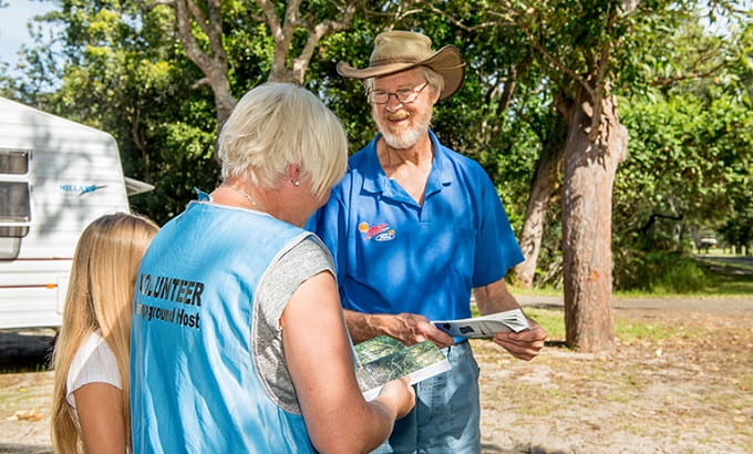 Mungo Brush campground host informs visitors, Myall Lakes National Park. Photo: John Spencer