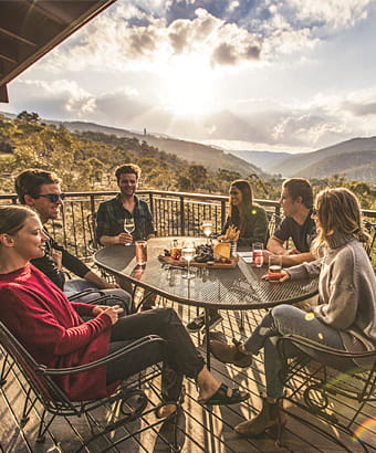 Group of friends on the balcony of Creel Lodge at sunset. Photo: Boen Ferguson/OEH