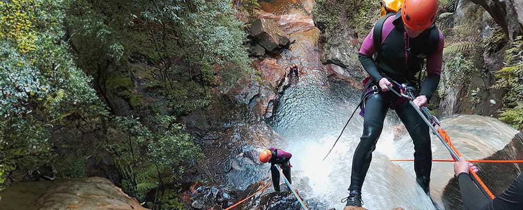 A person roping down a waterfall. Credit: James Waddell &copy; Eagle Rock Adventures