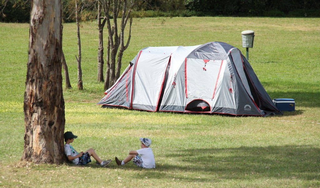 Children under a tree with their tent in the background at Bents Basin campground. Photo: John Yurasek &copy; OEH