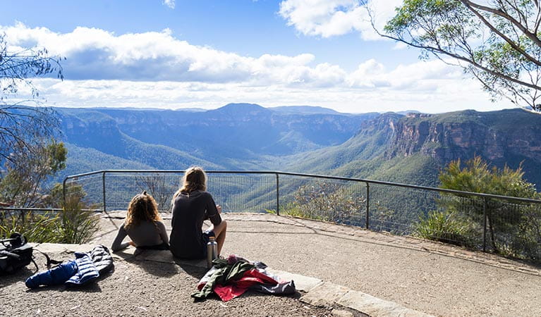 Hikers relax after a walk at Evans lookout, Blue Mountains National Park. Photo: Simone Cottrell/OEH.