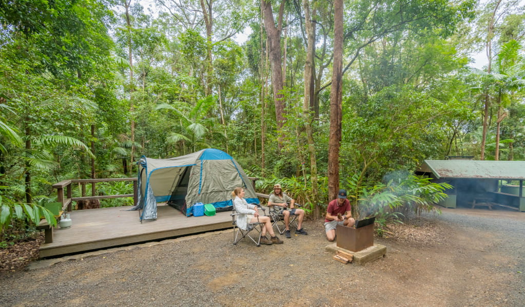 3 campers relaxing at their tent platform at Sheepstation Creek campground. Photo credit: John Spencer &copy; DPE