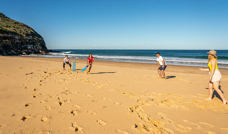 People playing a game of cricket along Tallow Beach, Bouddi National Park. Photo: John Spencer/DPIE.