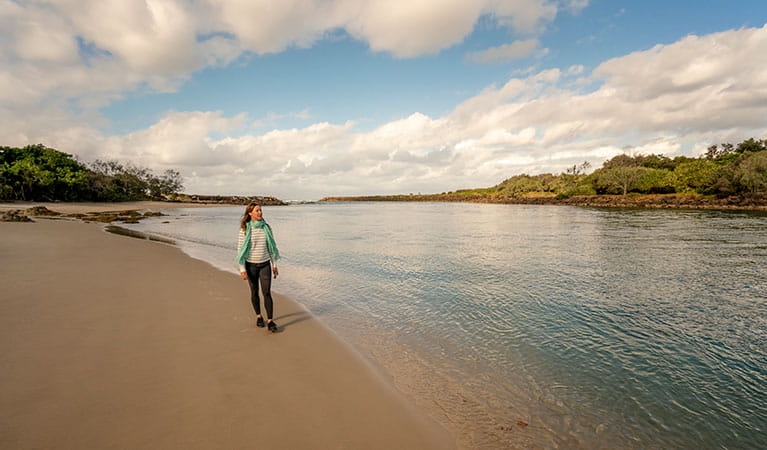  A woman walking along the beach at North Head walking track in Brunswick Heads Nature Reserve. Photo: John Spencer &copy; OEH