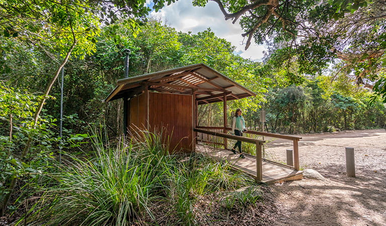 A woman walking down the ramp from the wheelchair-accessible toilet facilities at North Head walking track in Brunswick Heads Nature Reserve. Photo: John Spencer &copy; OEH