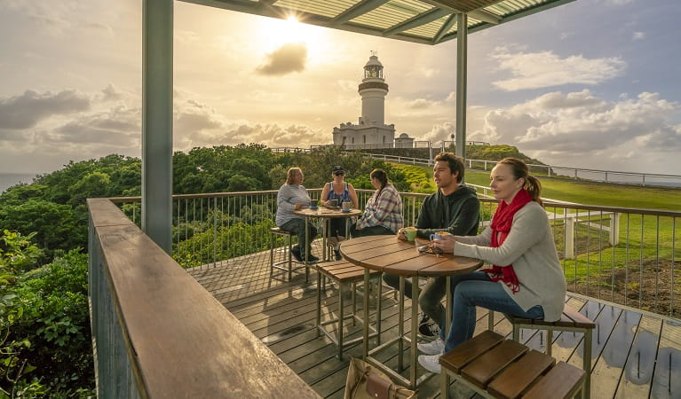 Visitors enjoying a coffee on the deck at Cape Byron Lighthouse Cafe. Photo: John Spencer/OEH
