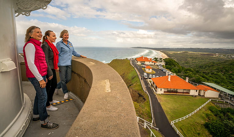 A tour group enjoy views from the top of Cape Byron Lighthouse, Cape Byron State Conservation Area. Photo: John Spencer/OEH.