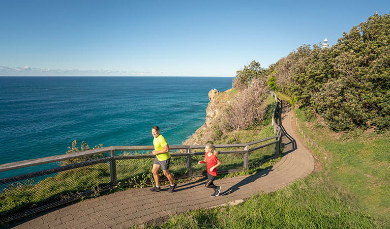 People jogging on the Cape Byron walking track. Photo: John Spencer &copy; OEH