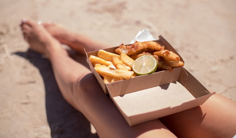 Fish and chips take out on the beach. Photo: Kyle James Healy