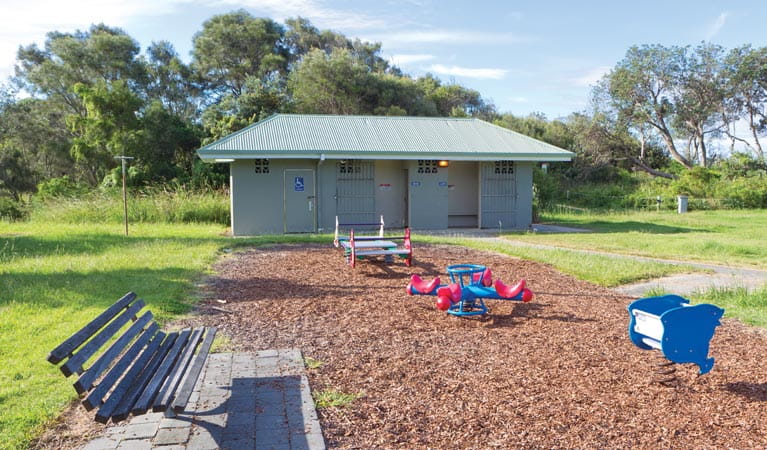 Seat beside picnic area playground, Coffs Coast Regional Park. Photo: Rob Cleary