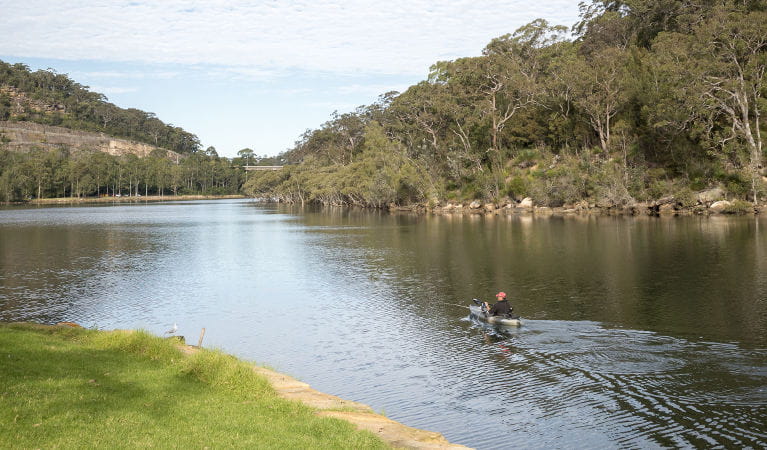 A person in a canoe glides down the river next to Davidson Park, in Garigal National Park. Photo: John Spencer/OEH
