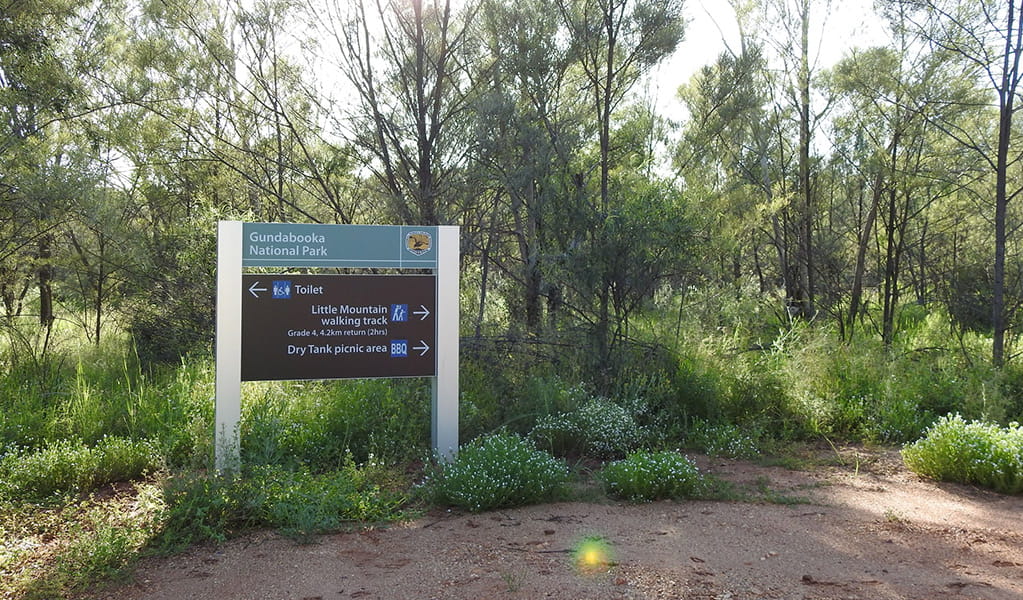 Photo of a sign pointing to toilets, Dry Tank picnic area and Little Mountain walking track at Gundabooka National Park. Photo credit: Jess Ellis/DPE &copy; DPE
