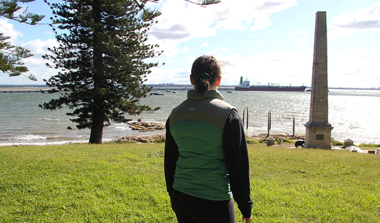 Girl looking out past Captain Cook Monument in Kurnell, Kamay Botany Bay National Park. Photo credit: Natasha Webb &copy; DPIE