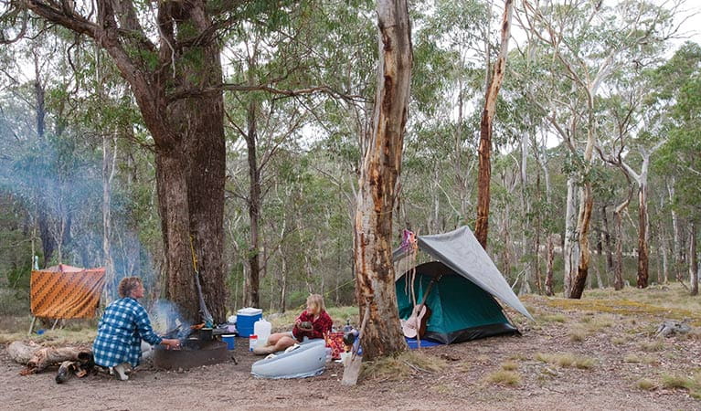 Campers outside a tent at Boyd River campground, Kanangra-Boyd National Park. Photo: Nick Cubbin &copy; DPIE