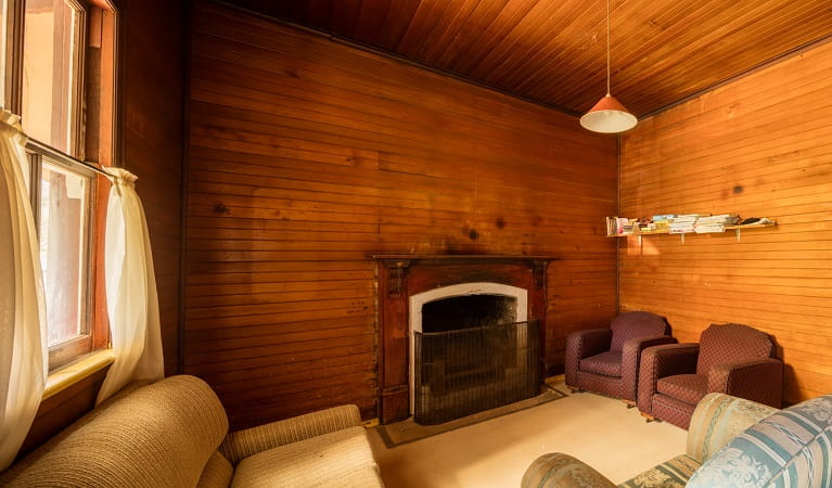 Daffodil Cottage fireplace and living room, Kosciuszko National Park. Photo: Murray Vanderveer/OEH