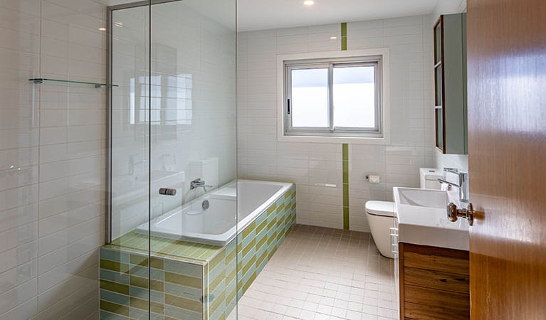 A bathroom with shower and bath in Creel Bay cottages. Photo: Photo &copy; Murray Vanderveer