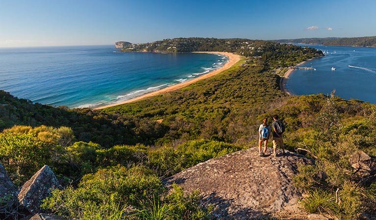 Two people walking to Barrenjoey Lighthouse, admiring coastal views over Ku-ring-gai Chase National Park. Photo: David Finnegan/OEH