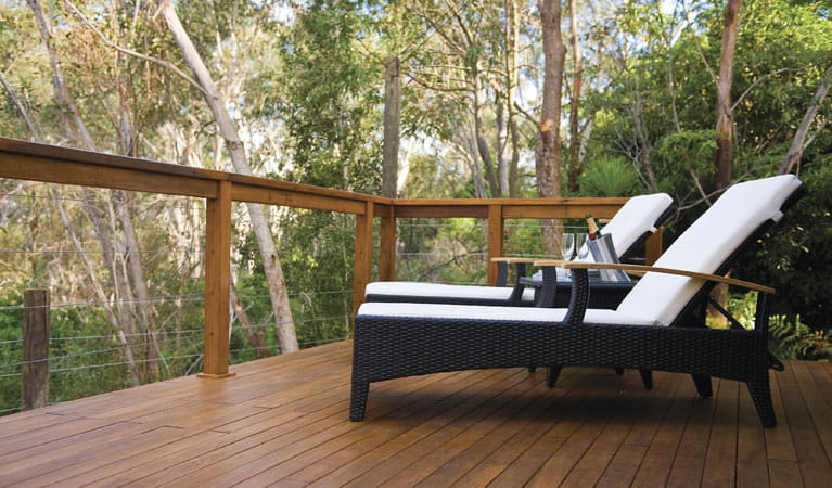 2 deck chairs on the balcony of Lane Cove safari tent, overlooking the bushland. Photo: OEH