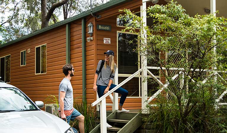 A couple walks up the stairs to their cabin in Lane Cove National Park. Photo: Caravel Content/OEH