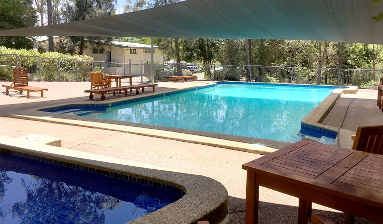 The shaded swimming pools, deck chairs and picnic tables at Lane Cove caravan park, Photo: Claire Franklin/OEH