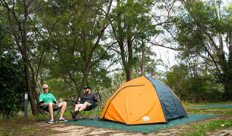 Two friends sitting next to their tent at Lane Cove caravan park. Photo: Caravel Content/OEH