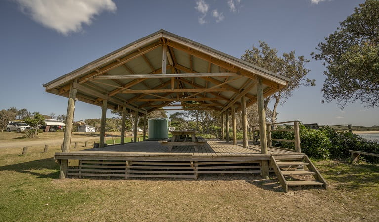 Picnic tables with large shelter at Point Plomer campground, Limeburners Creek National Park. Photo: John Spencer/OEH