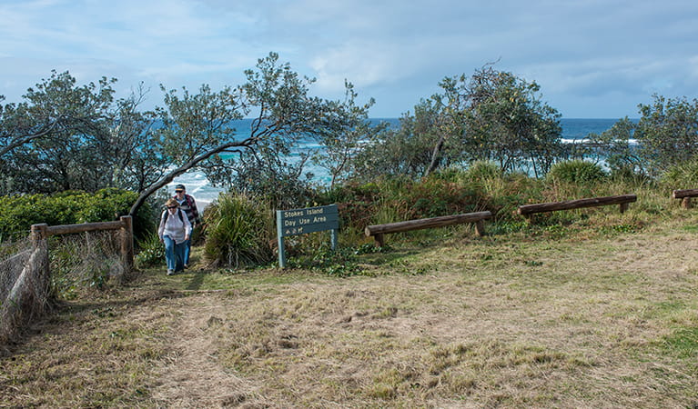 People walking up from the beach at Stokes picnic area, Meroo National Park. Photo: Michael van Ewijk/OEH