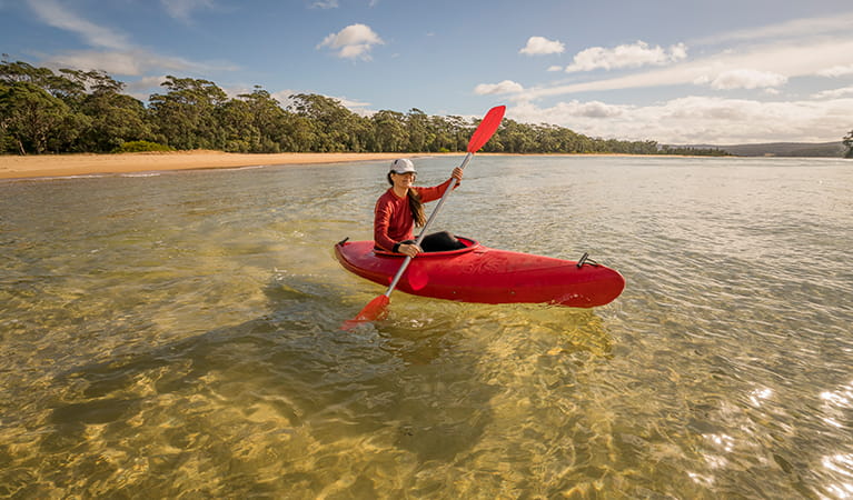 Woman in kayak at Bithry Inlet, at the mouth of Wapengo Lake in Mimosa Rocks National Park. Photo: John Spencer &copy; DPIE