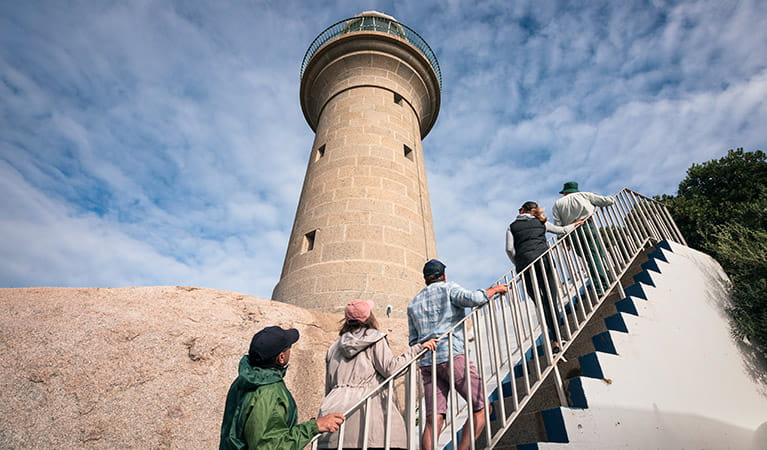 Visitors walk up stairs to the bottom of Montague Island Lighthouse. Photo: Daniel Tran/OEH