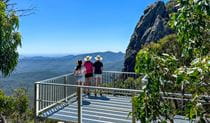 People admiring the view from West Kaputar Rock lookout, Mount Kaputar National Park. Photo: Louisa Anderson &copy; DCCEEW
