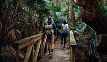 A couple walk along Durras Lake discovery trail in Murramarang National Park. Photo &copy; Melissa Findley
