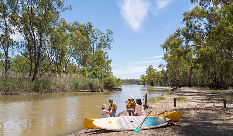 Family with lifejackets, paddle boards, canoe and paddles at Barmah Lakes day visitor area. Photo: B Ferguson/OEH 