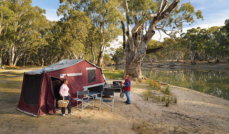 Campers using a barbecue outside their tent by the river bank, Murray Valley Regional Park. Photo: Gavin Hansford/DPIE