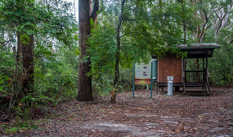 View of toilet block set in a sandy clearing surrounded by trees. Photo: John Spencer &copy; DPIE