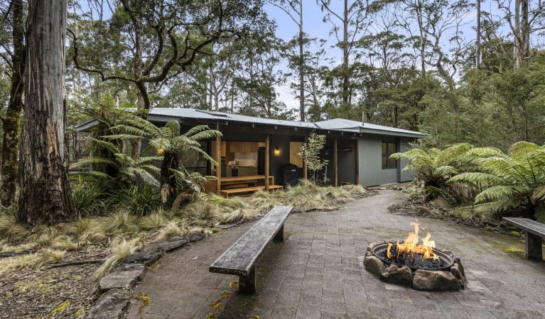 The exterior of The Residence with benches and a fire pit, in New England National Park. Photo: Mitchell Franzi &copy; DPIE