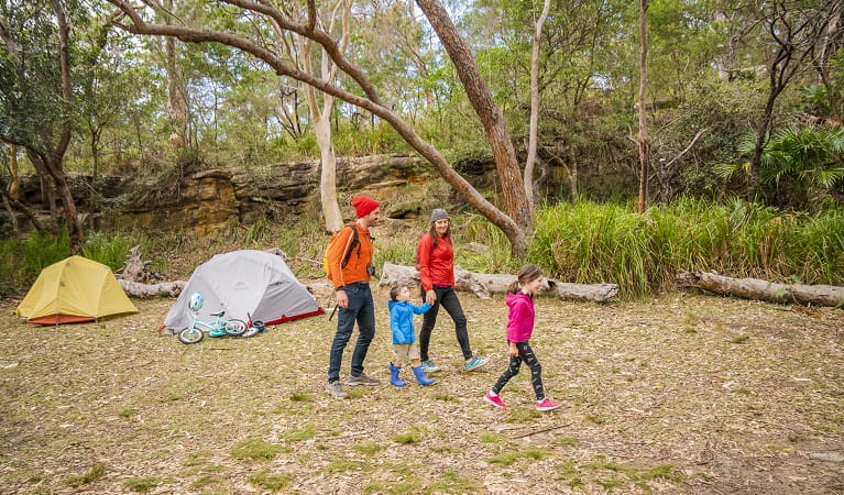 Family going for a stroll at Bonnie Vale campground, Royal National Park. Photo: John Spencer/OEH