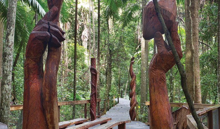 Large wooden sculptures of hand and fruit, Sea Acres National Park. Photo &copy; Robert Cleary