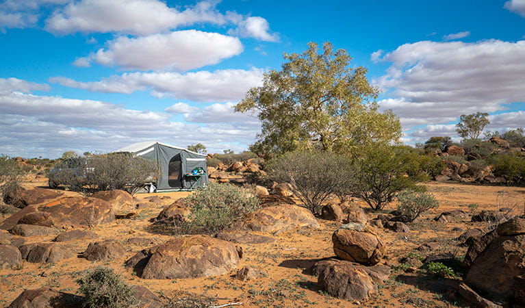 Camper trailer and boulders at Dead Horse Gully campground in Sturt National Park. Photo: John Spencer/DPIE