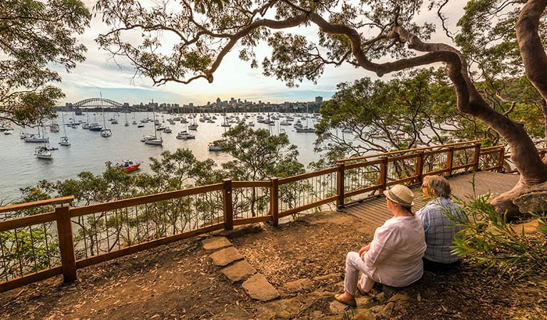 Two people enjoying the view along Bradleys Head to Chowder Bay walk, Sydney Harbour National Park. Photo credit: John Spencer &copy; DPIE