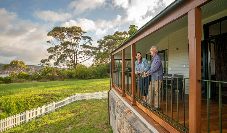 Two people standing on the back verandah of Middle Head Officers Quarters in Sydney Harbour National Park. Photo: John Spencer/DPIE