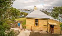 View of Steele Point Cottage from the embarkment with the Sydney Harbour skyline in the distance. Photo: John Spencer/OEH