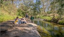 Family and NPWS Ranger on the banks of Middle Brook in Towarri National Park. Credit: John Spencer &copy; DPE