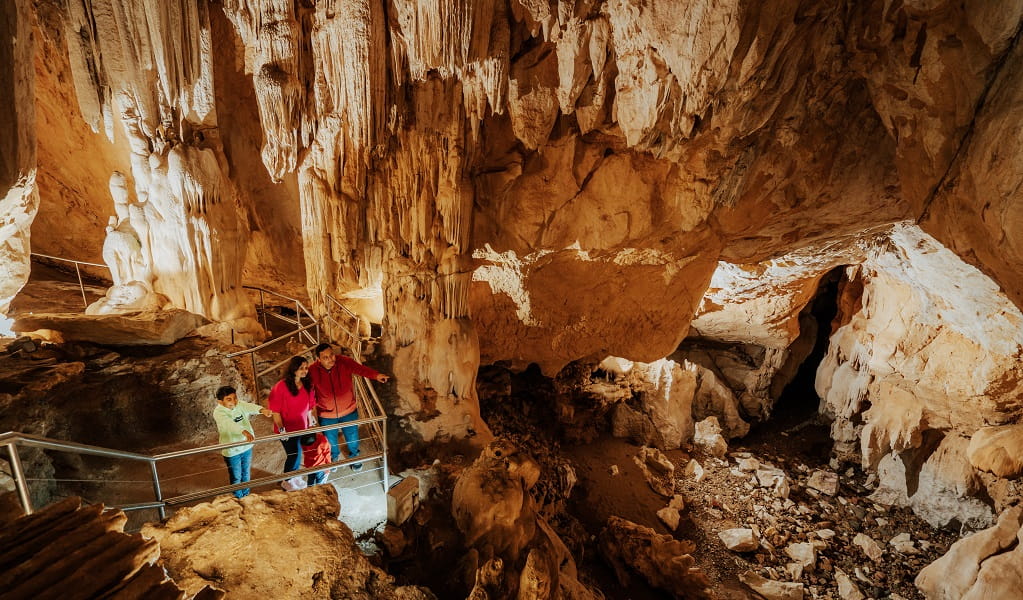 Visitors stand beneath impressive stalactites in Fig Tree Cave. Credit: Remy Brand/DPE &copy; Remy Brand