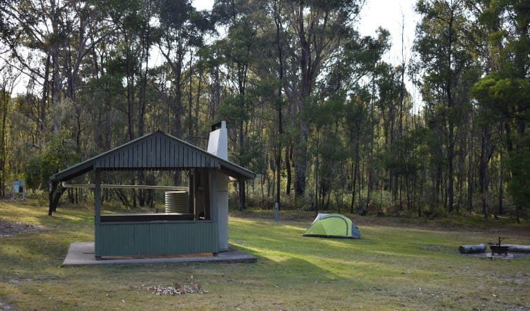 A picnic shelter with a tent in the background at Mogo campground, Yengo National Park. Photo: Sarah Brookes &copy; DPIE
