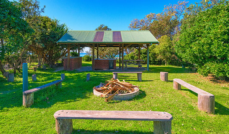 An area with benches and a firepit, perfect for groups at Illaroo group camping area in Yuraygir National Park. Photo: Jessica Robertson &copy; DPIE