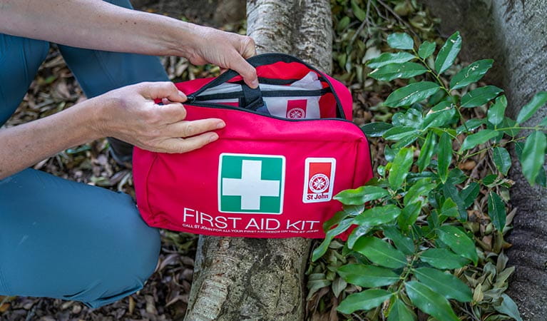Person opening up a first aid kit. Photo: John Spencer/DPIE