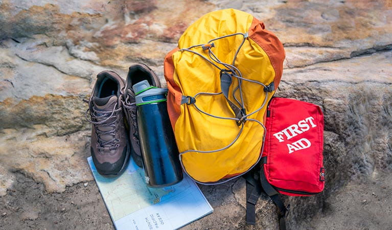 Backpack, first aid kit, water bottle, hiking shoes and map. Photo: John Spencer/DPIE