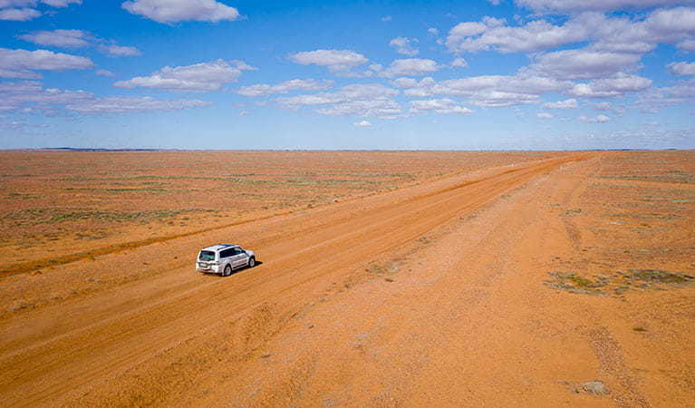Aerial view of 4WD driving on the red earth in Sturt National Park. Photo: John Spencer/DPIE